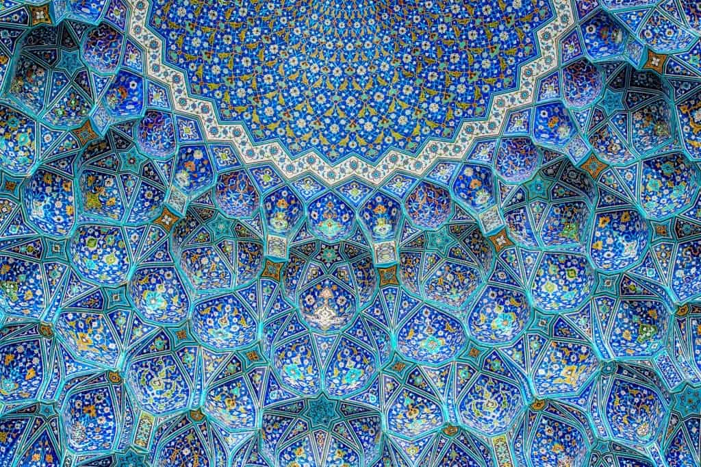 Muqarnas is one of the unique visual aspects of Islamic architecture and intellectuals have had significant differences in their opinions as to whether there is an architecture named “Islamic” and what are its main meanings and features. Muqarnas ornamentation depicts art and architecture that was historically built in Muslim-ruled areas, built for Muslim patrons, or made by Muslim artists. As Islam is not only a religion but also a method of life, it developed a different culture with its special artistic language that is mirrored in art and architecture throughout the Islamic world. Ceiling and wall tilework at the Shah Mosque on Naghshe JahanSquare, Isfahan saeid shakouri Islamic geometric pattern saeidshakouri.com